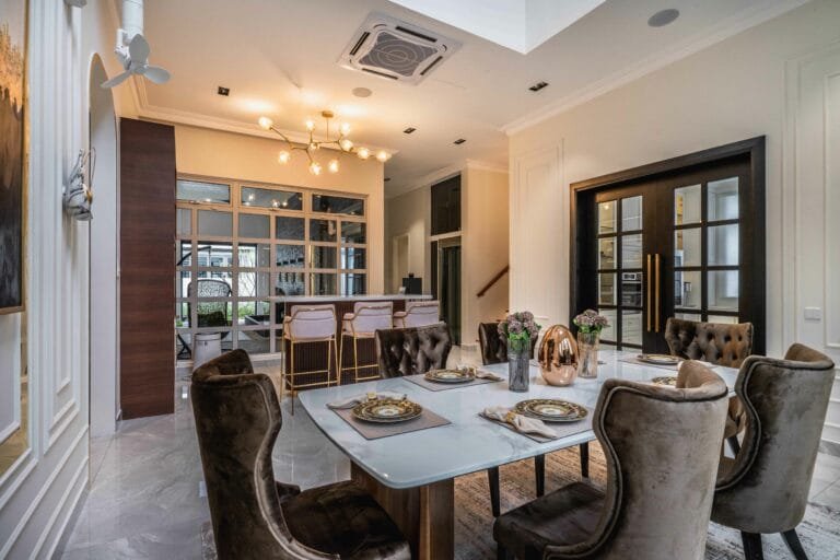 Dining room with tufted velvet chairs, a stone-topped table and a set table, EcoSpring, Johor Bahru, Malaysia, by Blaine Robert Design