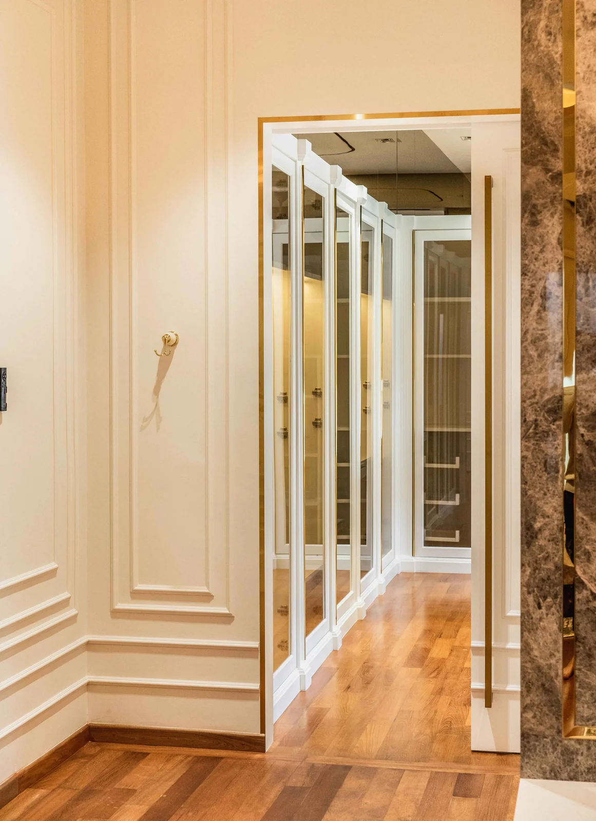 Mirrored wardrobe doors along a dressing corridor with marble walls, Eco Spring, Johor Bahru, Malaysia, by Blaine Robert Design